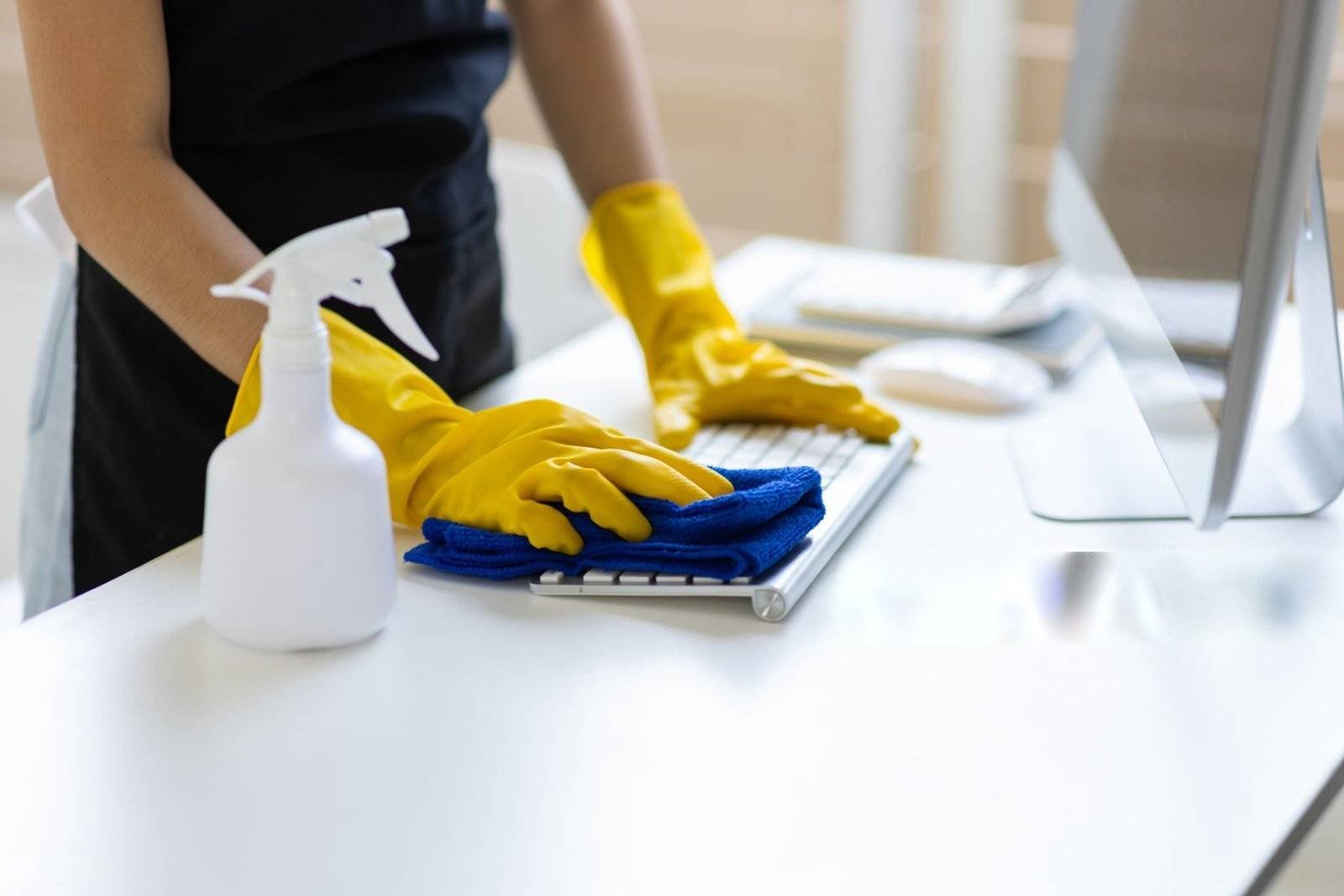 Office cleaner wiping desks in an Amsterdam workspace